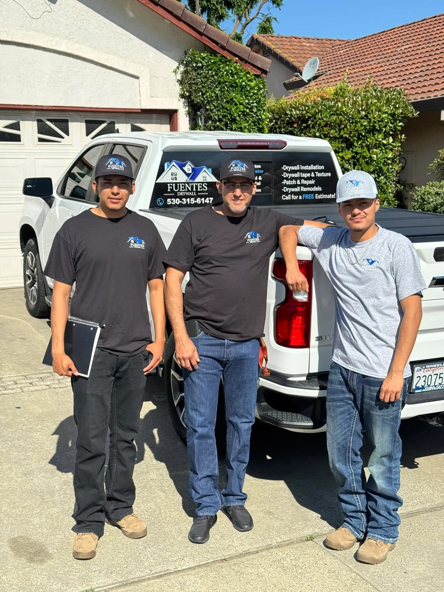 The Fuentes Drywall crew in front of the company truck