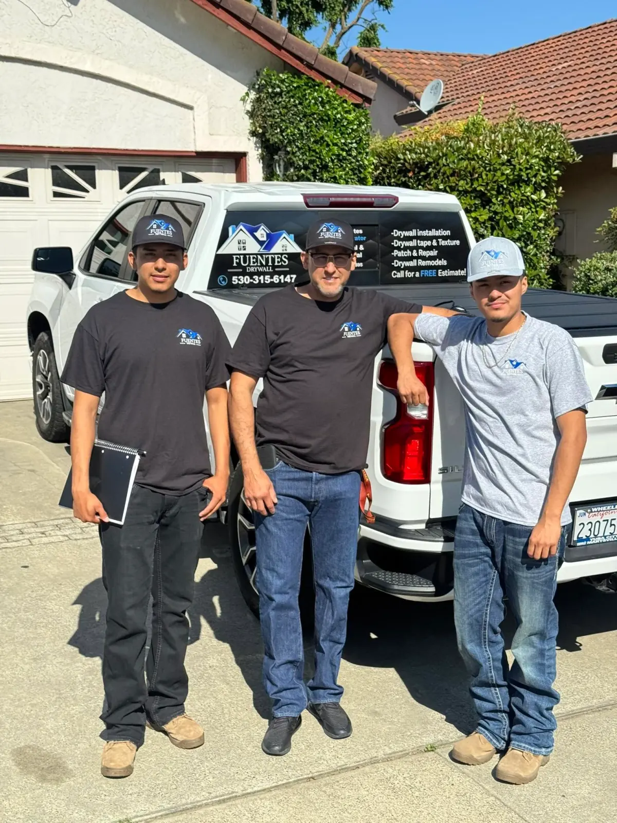 The Fuentes Drywall crew in front of the company truck